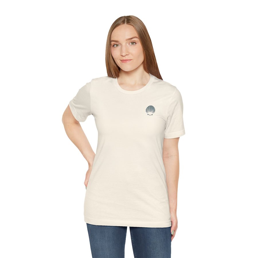 Woman wearing the Just One More Shell tee in natural cream, with a small Shellwake logo on the chest