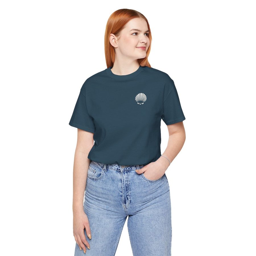 Woman wearing the Walk Slowly, Look Down tee in deep teal, with a small Shellwake logo on the chest